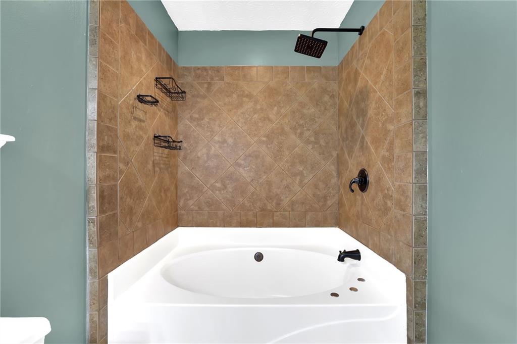 1805 Tribble Ridge Drive Lawrenceville, GA 30045 - Photo 35 of 46 a bathroom with a white bath tub