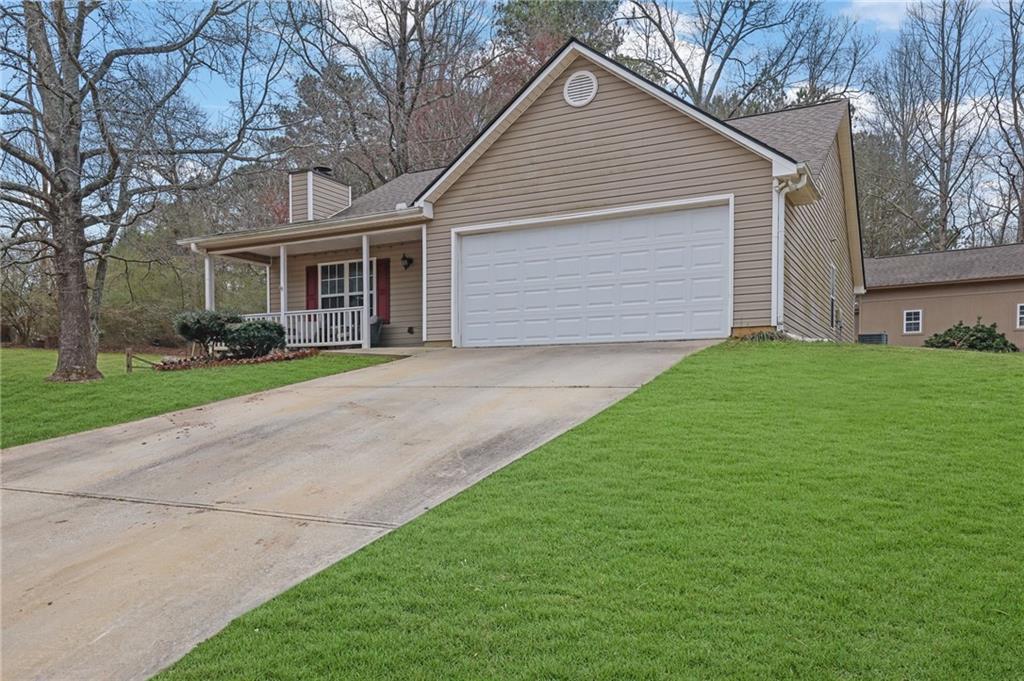 1805 Tribble Ridge Drive Lawrenceville, GA 30045 - Photo 4 of 46 a front view of house with yard and green space