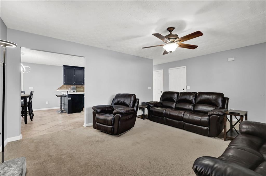 1805 Tribble Ridge Drive Lawrenceville, GA 30045 - Photo 8 of 46 a living room with furniture and a ceiling fan