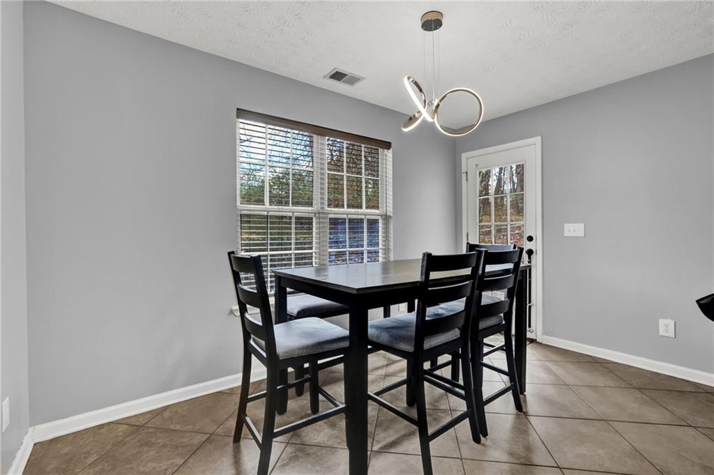 1805 Tribble Ridge Drive Lawrenceville, GA 30045 - Photo 9 of 46 a view of a dining room with furniture and window