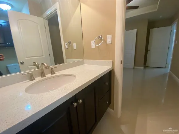a bathroom with a double vanity sink and a mirror