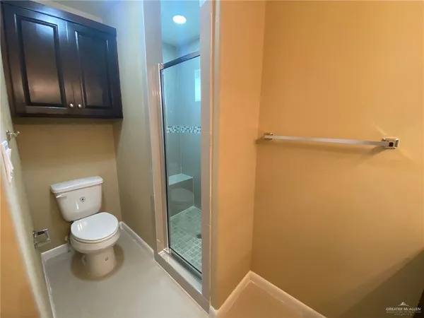 a bathroom with a toilet and a shower