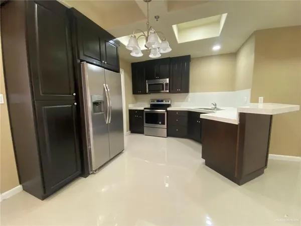 a kitchen with kitchen island a sink stainless steel appliances and cabinets