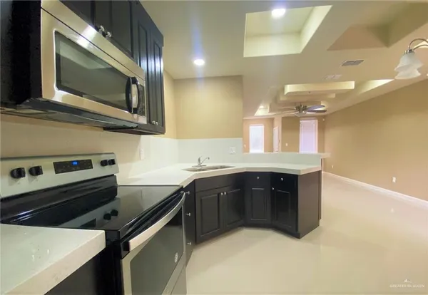 a kitchen with a sink and stainless steel appliances