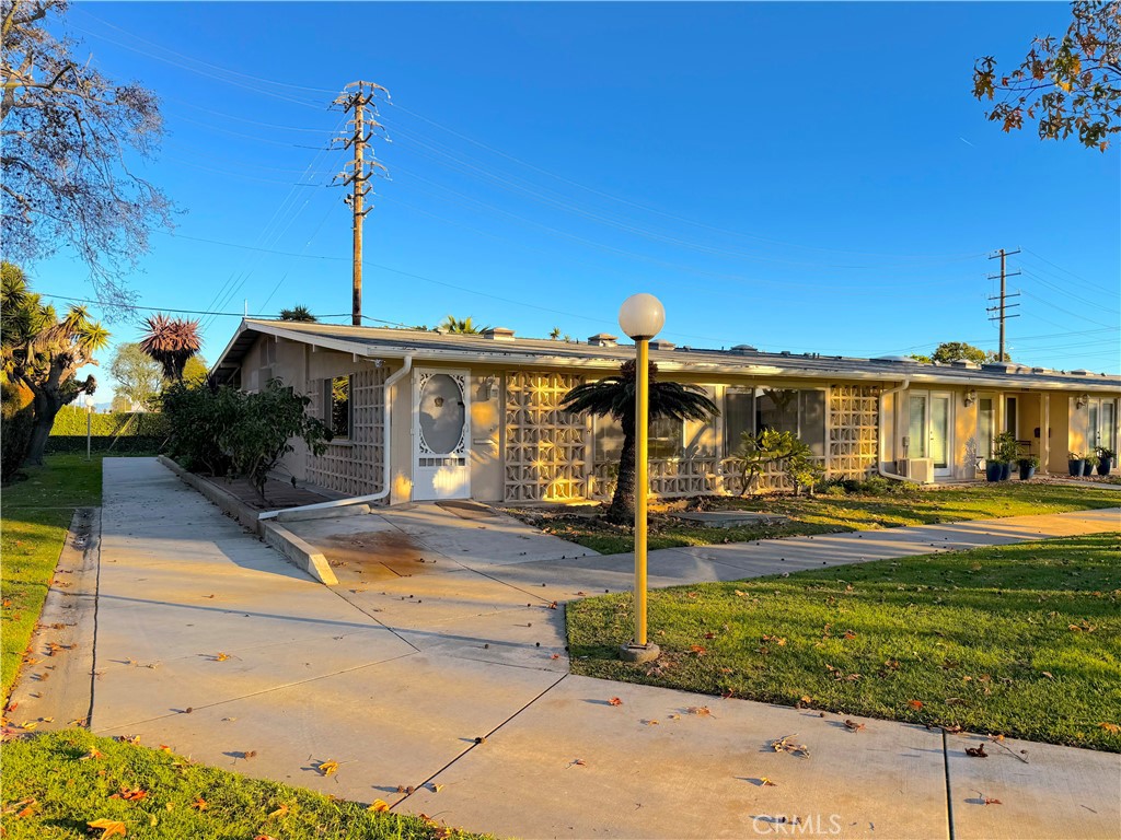 1240 Scioto Road, Unit 228F Seal Beach, CA 90740 - Photo 1 of 38 a front view of a house with garden