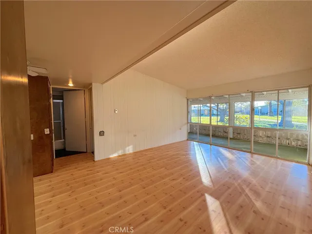 a view of an empty room with glass door