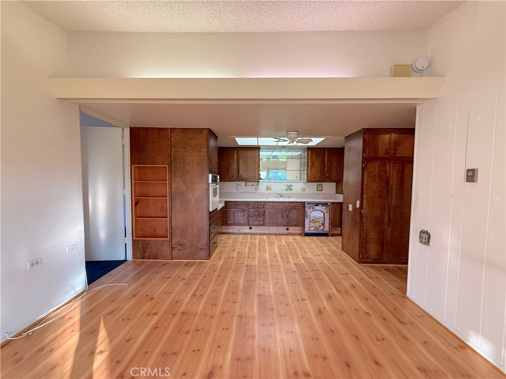 1240 Scioto Road, Unit 228F Seal Beach, CA 90740 - Photo 19 of 38 a large kitchen with wooden floor and a refrigerator
