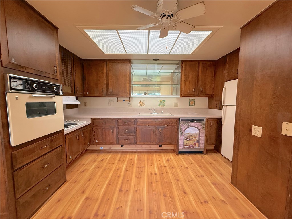 1240 Scioto Road, Unit 228F Seal Beach, CA 90740 - Photo 20 of 38 a large kitchen with a stove a sink dishwasher and a refrigerator