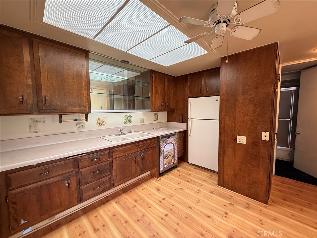 1240 Scioto Road, Unit 228F Seal Beach, CA 90740 - Photo 21 of 38 a kitchen with stainless steel appliances sink refrigerator and cabinets