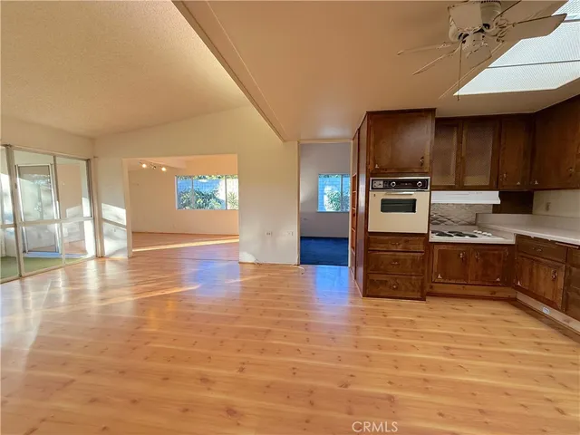 a kitchen with stainless steel appliances a refrigerator and a stove top oven