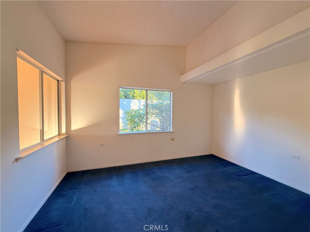 1240 Scioto Road, Unit 228F Seal Beach, CA 90740 - Photo 24 of 38 an empty room with wooden floor and windows