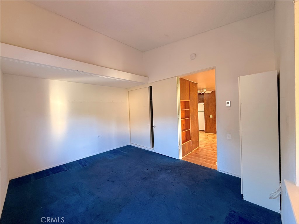 1240 Scioto Road, Unit 228F Seal Beach, CA 90740 - Photo 25 of 38 a view of an empty room with wooden floor and a window