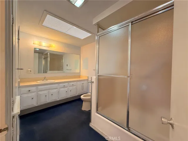 a bathroom with a double vanity sink and mirror with shower
