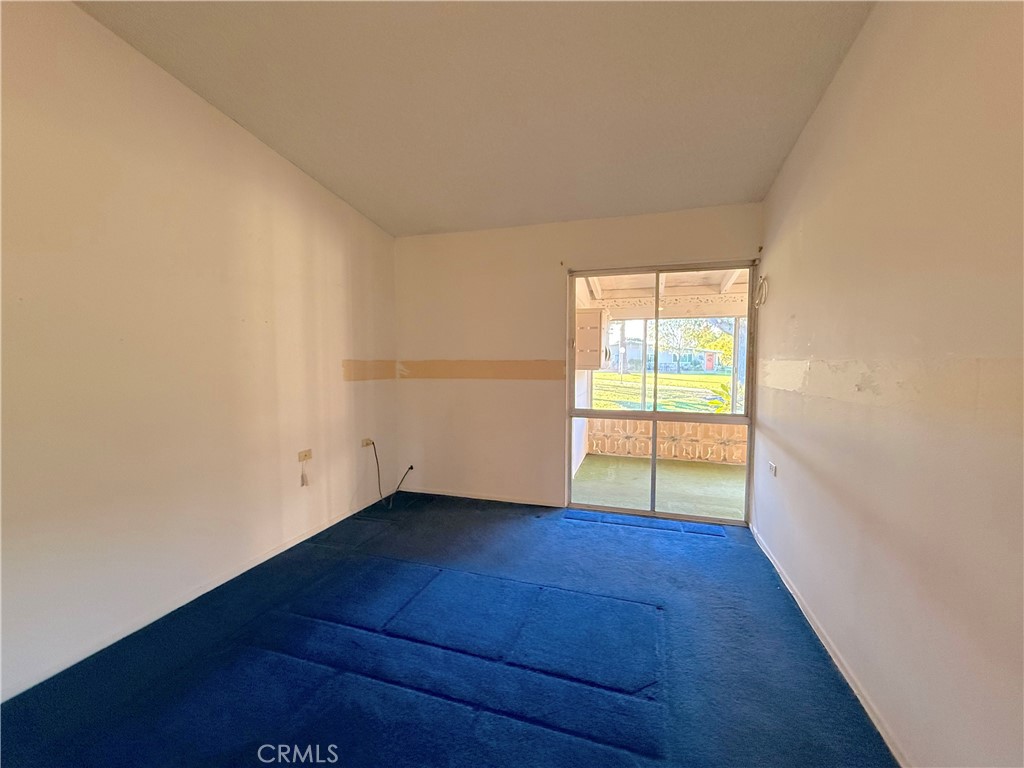 1240 Scioto Road, Unit 228F Seal Beach, CA 90740 - Photo 29 of 38 an empty room with wooden floor and windows