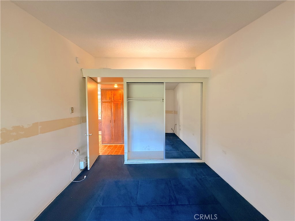 1240 Scioto Road, Unit 228F Seal Beach, CA 90740 - Photo 30 of 38 a view of an empty room with wooden floor and a window
