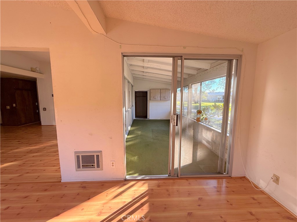 1240 Scioto Road, Unit 228F Seal Beach, CA 90740 - Photo 10 of 38 a view of a hallway with wooden floor and a living room