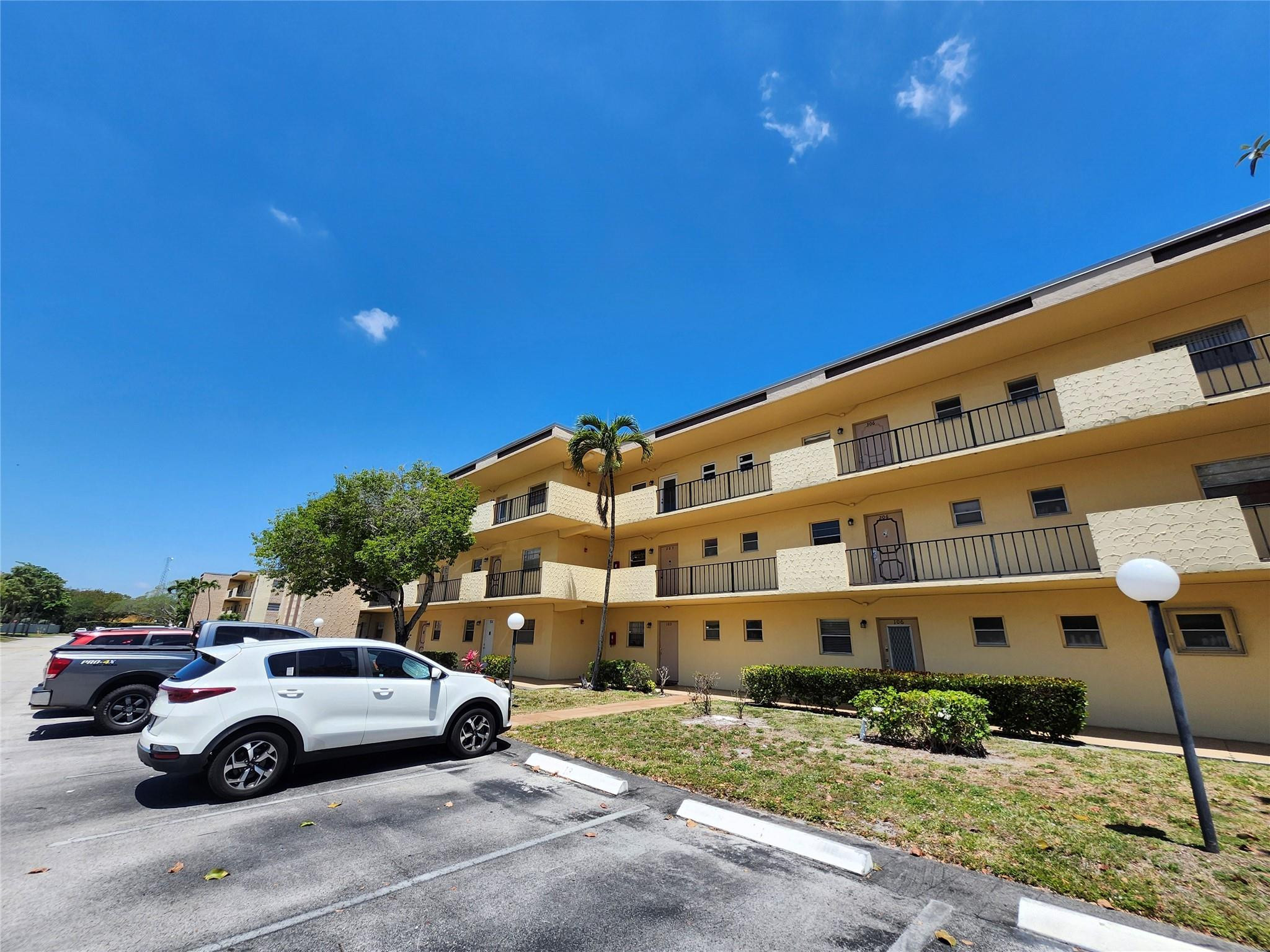 301 Cambridge Road, Unit 301 Hollywood, FL 33024 - Photo 1 of 31 a view of a cars parked in front of a building