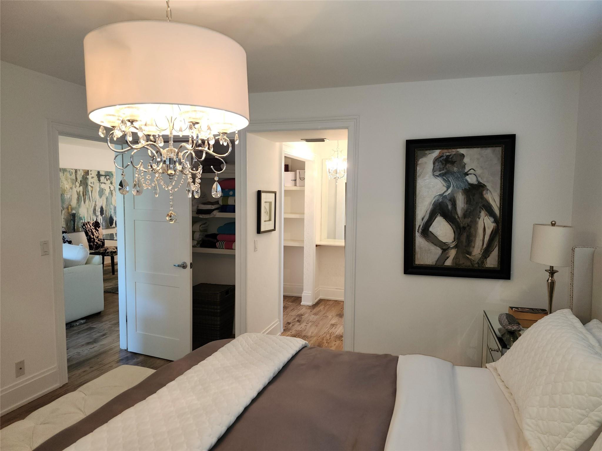 301 Cambridge Road, Unit 301 Hollywood, FL 33024 - Photo 15 of 31 a bedroom with a bed and a chandelier