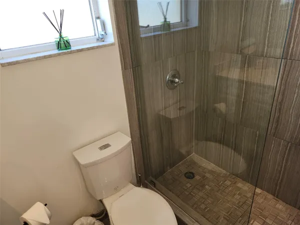 a bathroom with a toilet a sink and shower