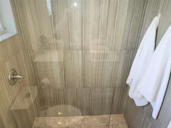a bathroom with a shower and a tub