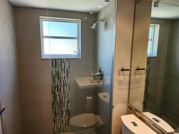 a bathroom with a toilet sink and shower