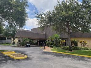 301 Cambridge Road, Unit 301 Hollywood, FL 33024 - Photo 26 of 31 a view of swimming pool with large trees and a small yard