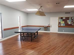 301 Cambridge Road, Unit 301 Hollywood, FL 33024 - Photo 28 of 31 a view of a dining room with furniture and wooden floor