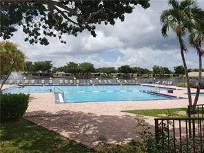 a view of yard with swimming pool and green space