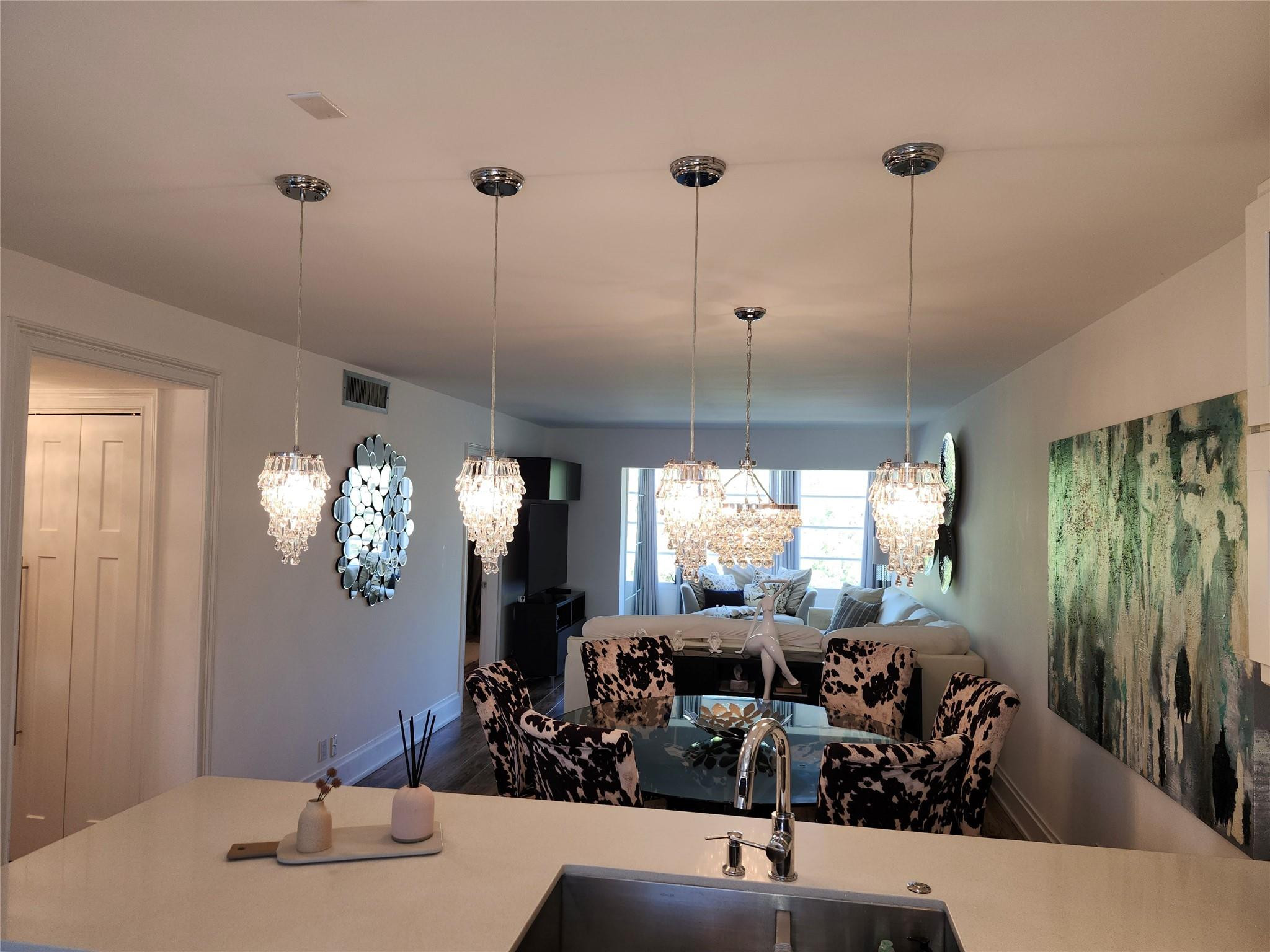 301 Cambridge Road, Unit 301 Hollywood, FL 33024 - Photo 7 of 31 a very nice looking dining room with a large window and chandelier