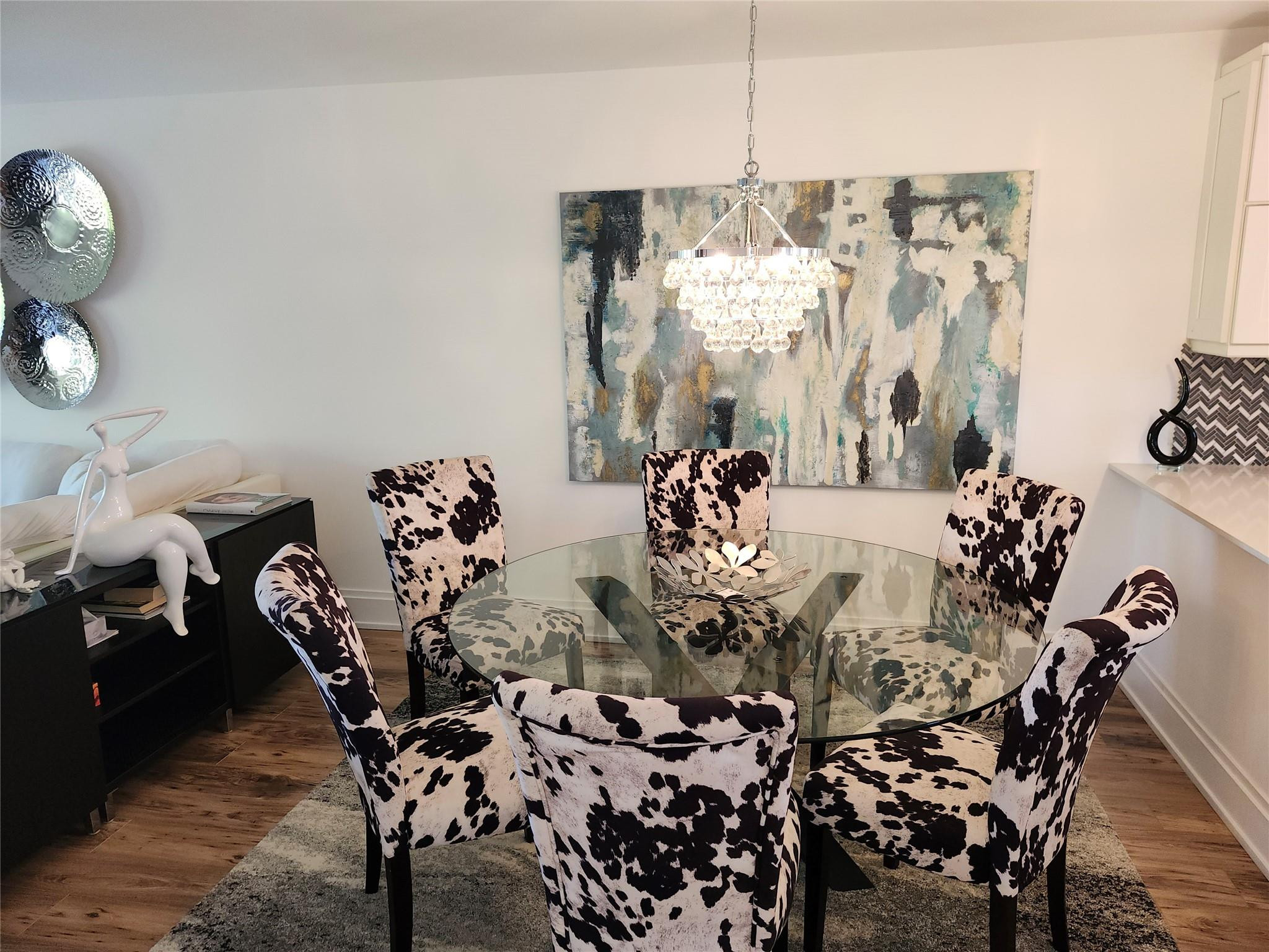 301 Cambridge Road, Unit 301 Hollywood, FL 33024 - Photo 9 of 31 a view of a dining room and livingroom with furniture wooden floor a chandelier
