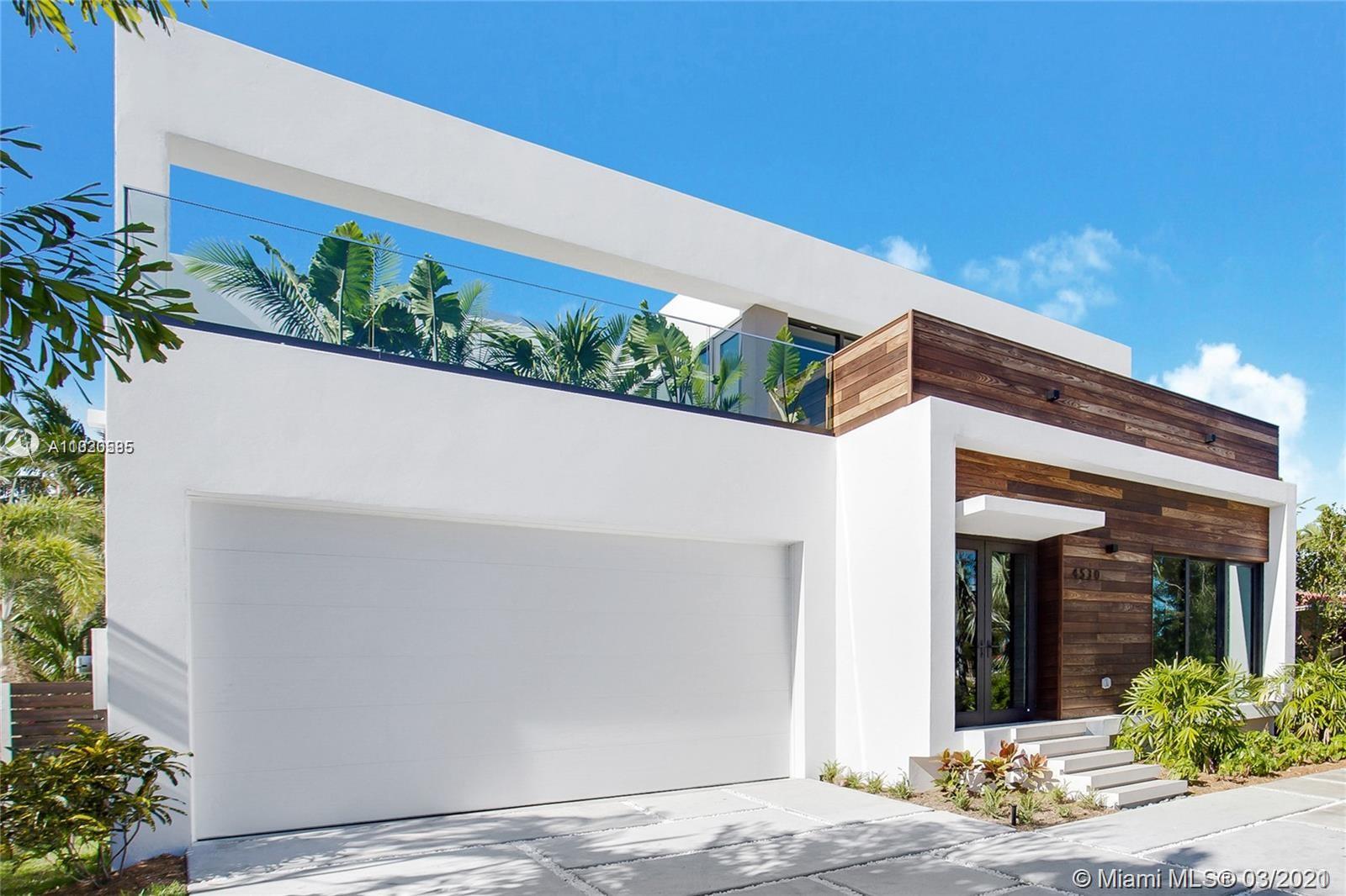 front view of a house with potted plants