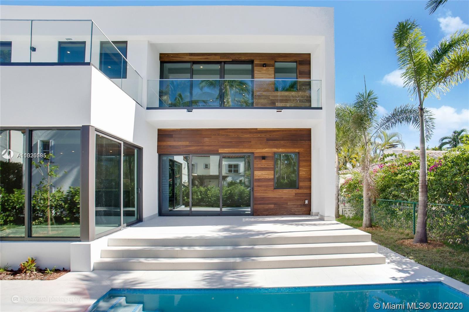 4530 Alton Road Miami Beach, FL 33140 - Photo 2 of 25 a view of a house with potted plants and a yard