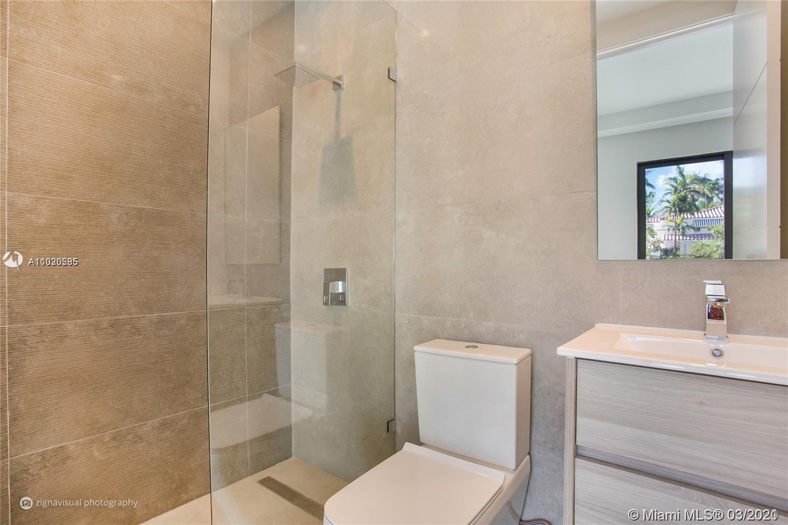 4530 Alton Road Miami Beach, FL 33140 - Photo 15 of 25 a bathroom with a sink a toilet and shower