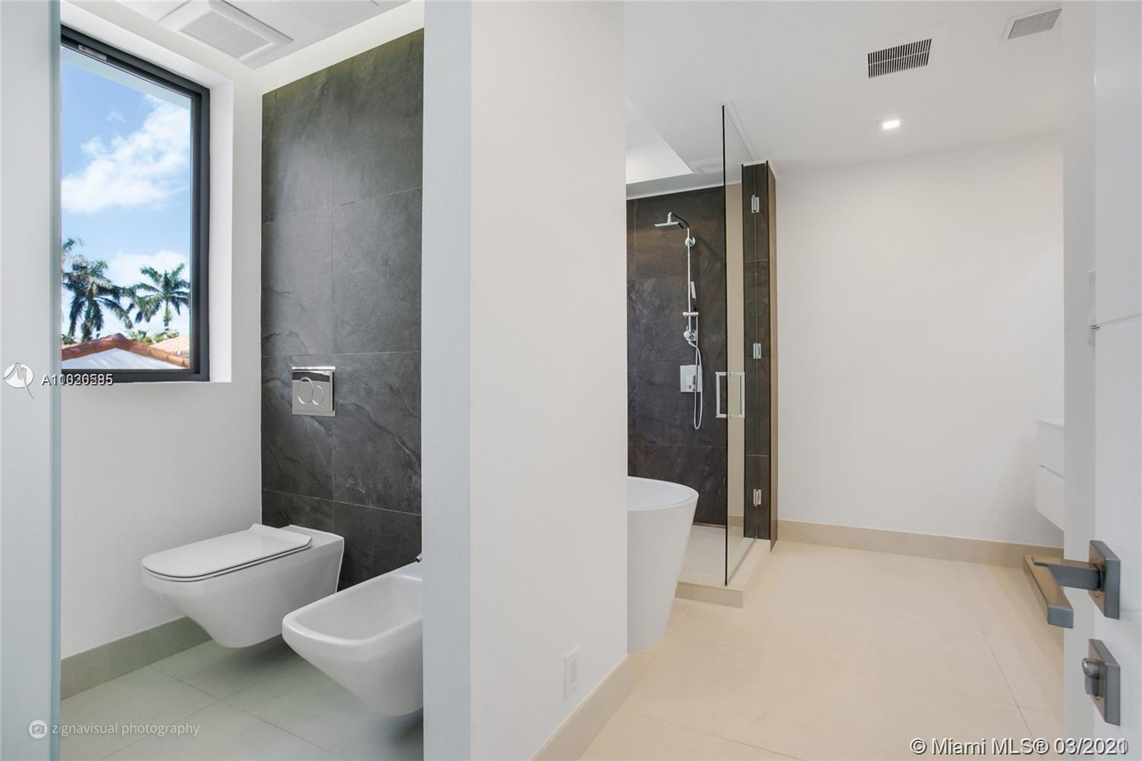 4530 Alton Road Miami Beach, FL 33140 - Photo 21 of 25 a bathroom with a toilet sink and shower