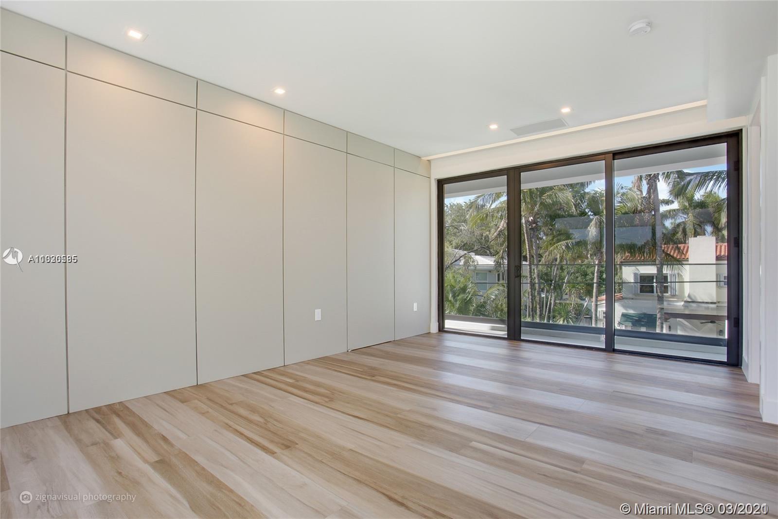 4530 Alton Road Miami Beach, FL 33140 - Photo 23 of 25 a view of an empty room with wooden floor and a window