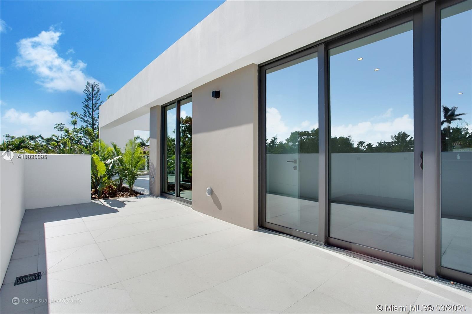 4530 Alton Road Miami Beach, FL 33140 - Photo 4 of 25 a view of a glass door with a balcony