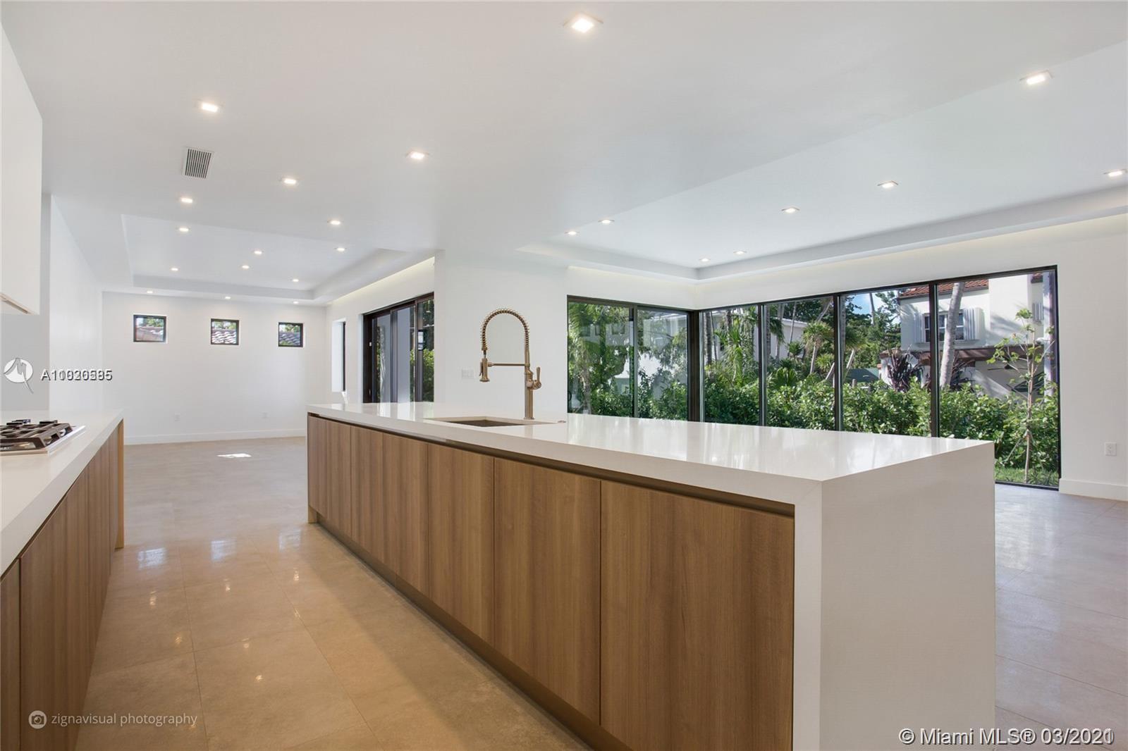4530 Alton Road Miami Beach, FL 33140 - Photo 8 of 25 a view of a living room and kitchen with a large window