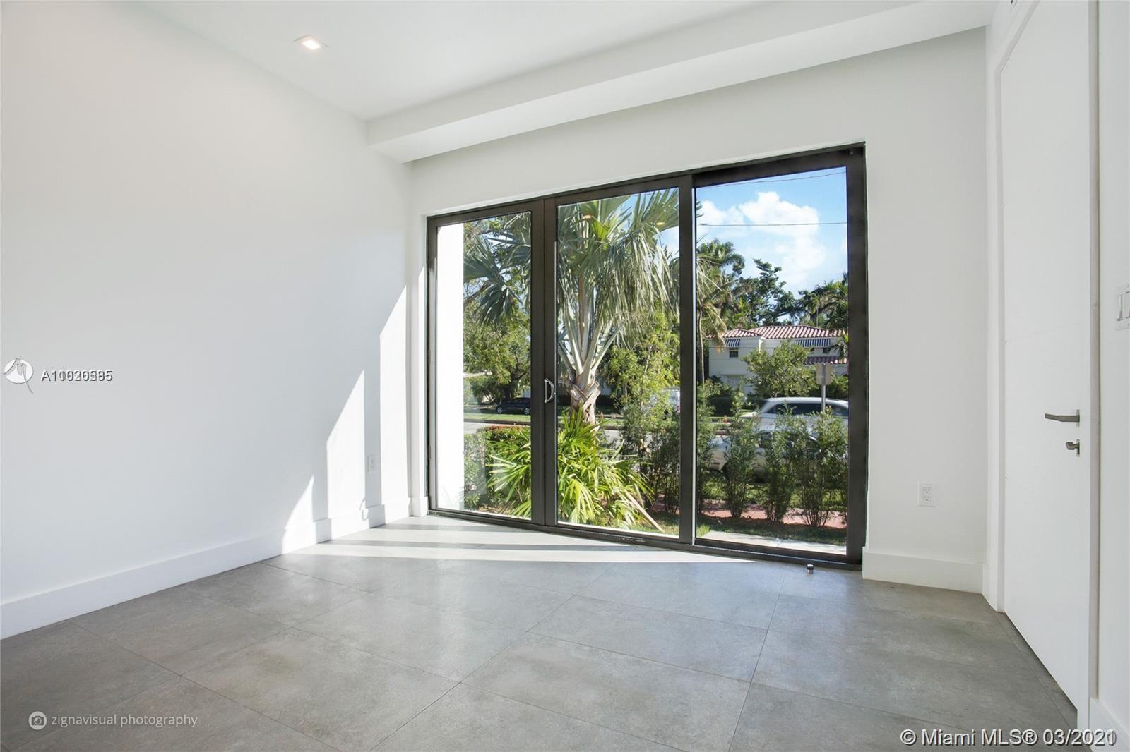 4530 Alton Road Miami Beach, FL 33140 - Photo 10 of 25 wooden floor and window in an empty room