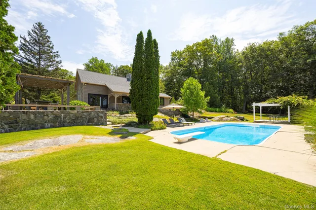 a view of a swimming pool with an outdoor space and seating area