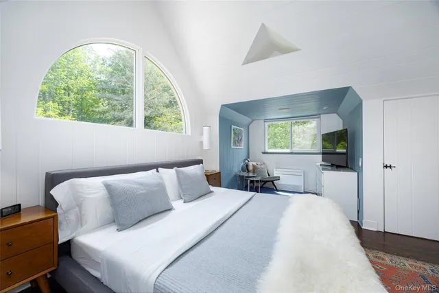 a bedroom with a large bed and a window