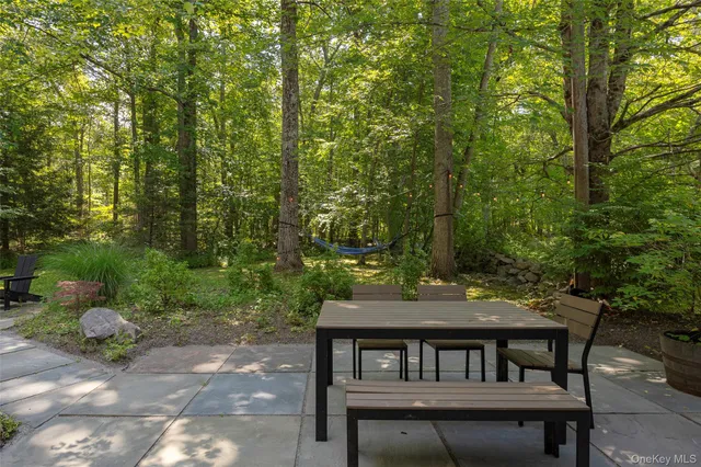 a view of a patio with couple of chairs
