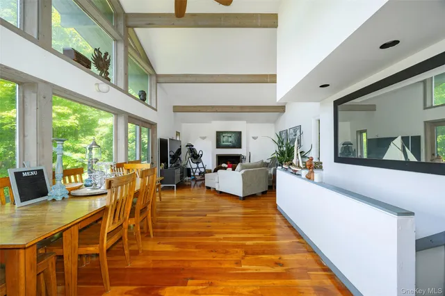 a living room with furniture large window and flat screen tv
