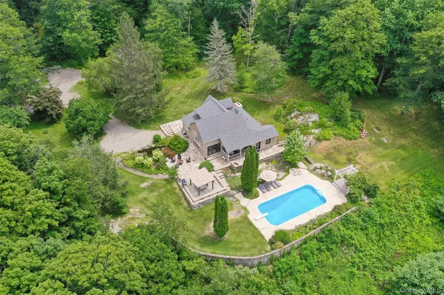 an aerial view of residential house with outdoor space and swimming pool