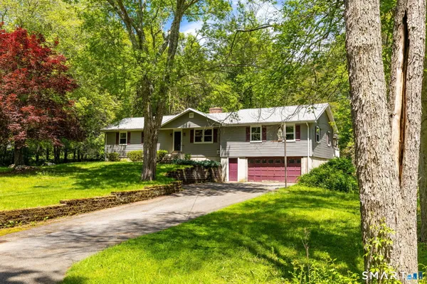 a front view of house with yard and green space