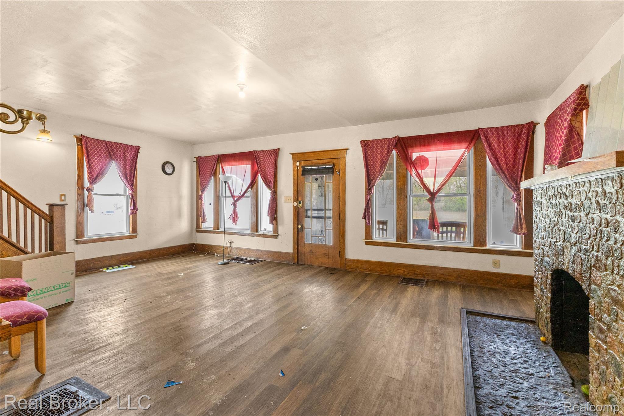 352 Perry Street Pontiac, MI 48342 - Photo 9 of 30 Unfurnished living room with dark wood-style floors, plenty of natural light, and a fireplace