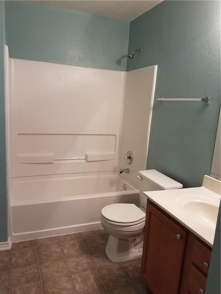 273 Tower Drive Kyle, TX 78640 - Photo 11 of 13 a bathroom with a granite countertop toilet and a sink