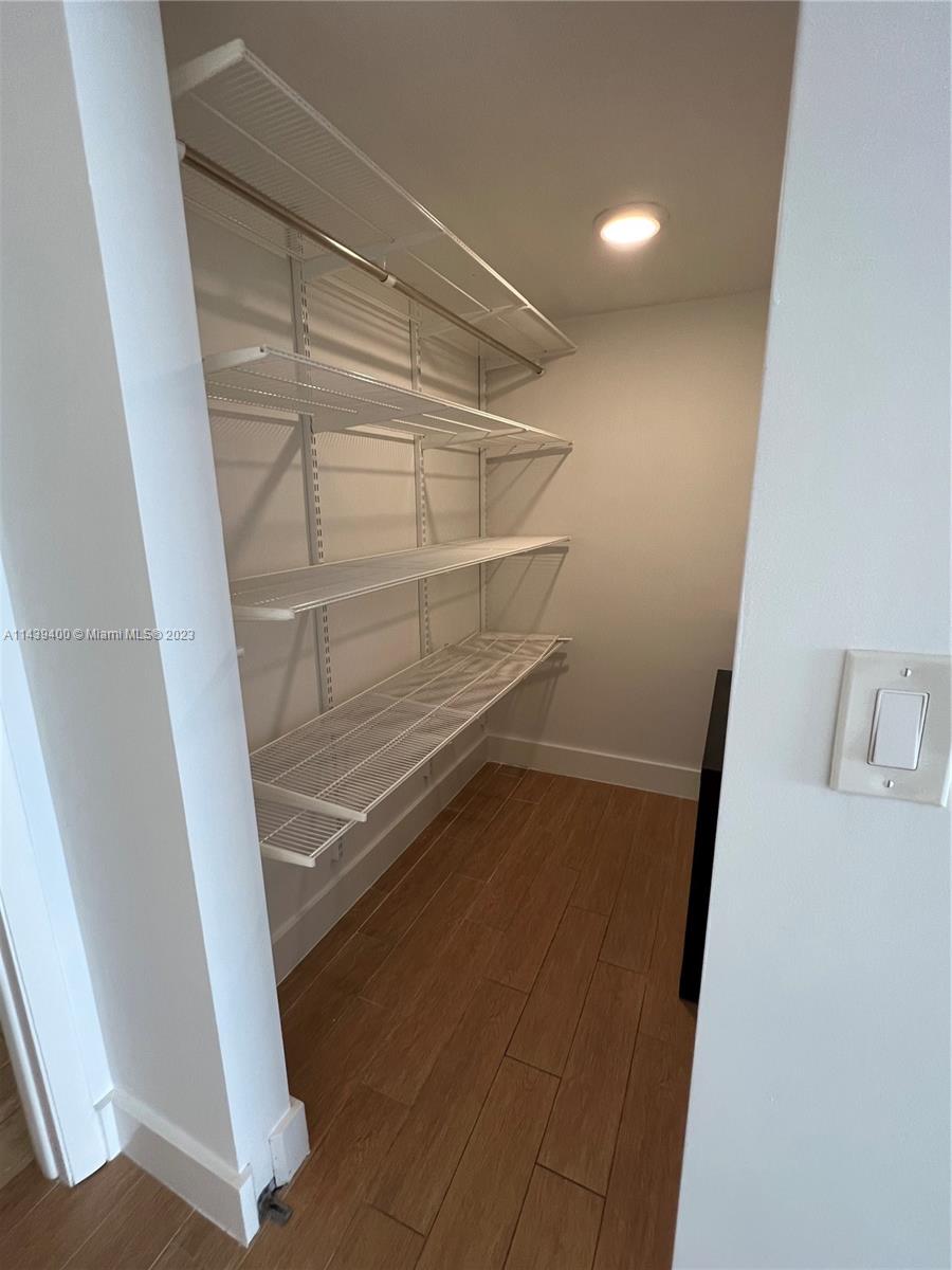 1915 Brickell Avenue, Unit TH16 Miami, FL 33129 - Photo 19 of 36 a view of walk in closet with empty racks