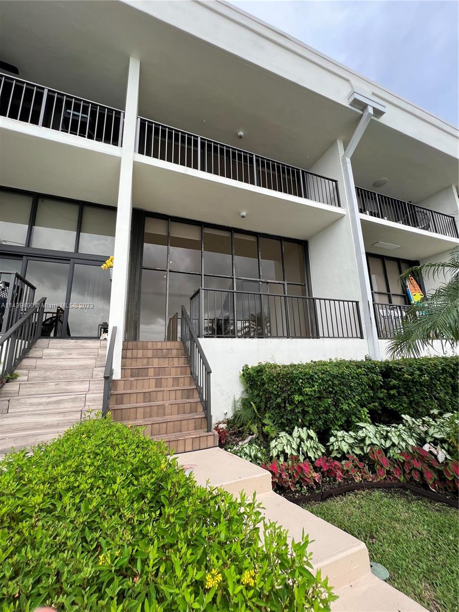 1915 Brickell Avenue, Unit TH16 Miami, FL 33129 - Photo 2 of 36 a front view of a house with a garden
