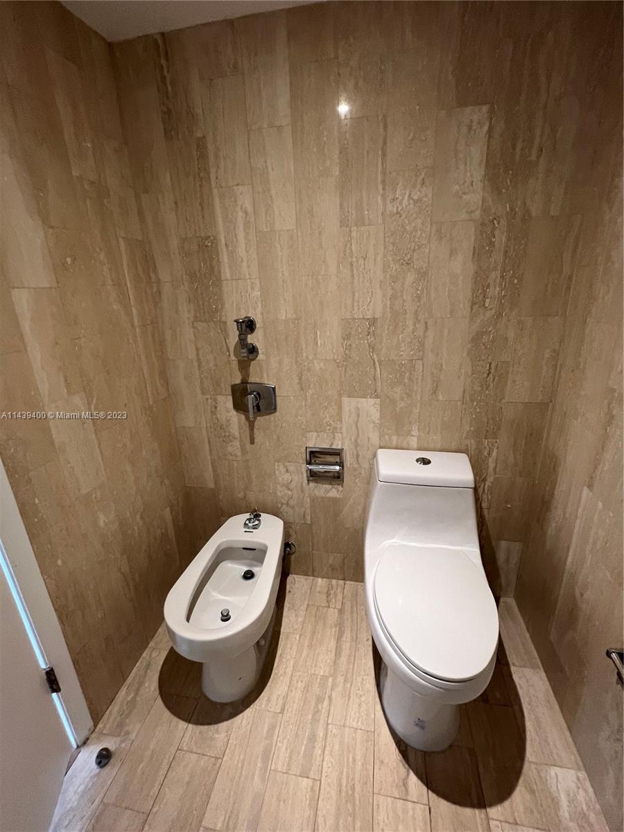 1915 Brickell Avenue, Unit TH16 Miami, FL 33129 - Photo 21 of 36 a bathroom with a toilet and a sink