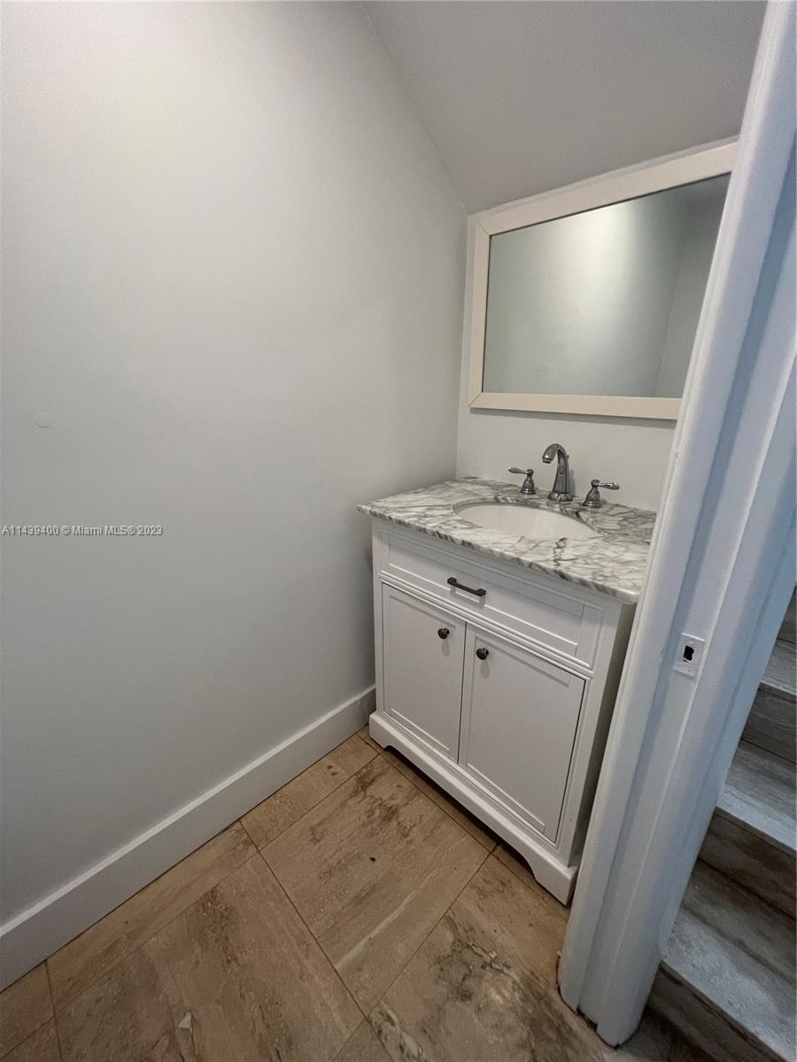 1915 Brickell Avenue, Unit TH16 Miami, FL 33129 - Photo 35 of 36 a bathroom with a sink a vanity and a mirror